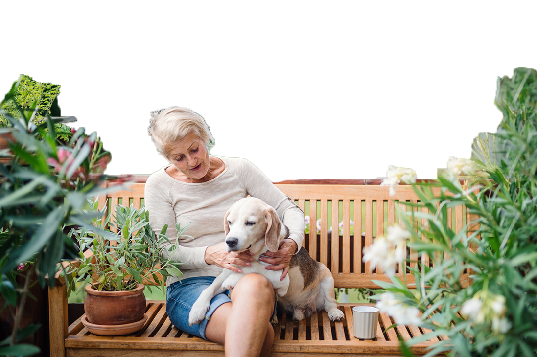 Senior woman with dog on bench