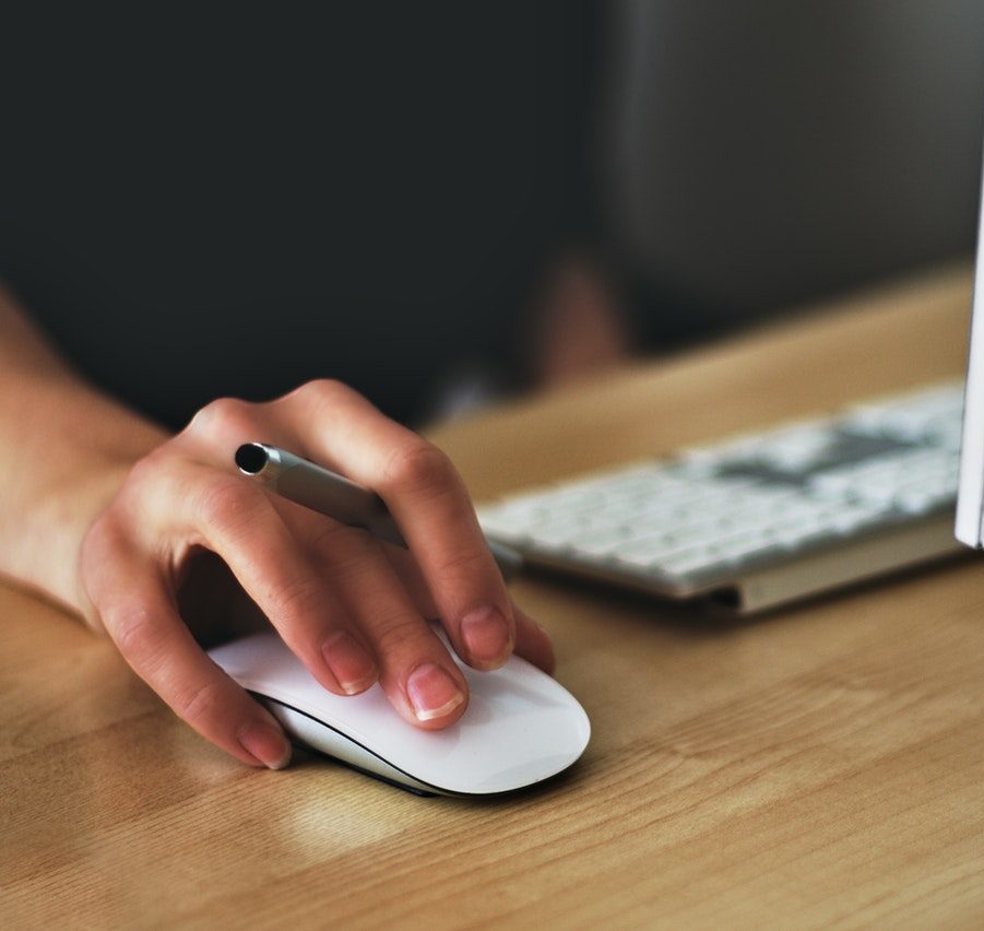 cropped image of hand using computer mouse